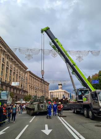 Ukraine, Kyiv, August 2022: Exhibition of Russian military equipment destroyed by the armed forces of Ukraine on Independence Day of Ukraine on Independence Square. Crane unloads machinery.のeditorial素材
