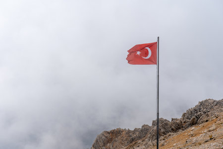 Turkish flag on the Tahtali Mountain in the Cloudsの写真素材