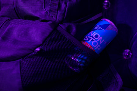 KYIV, UKRAINE - JULY 25, 2023: Can Non Stop energy drink in a backpack of a tourist in a nightclubのeditorial素材