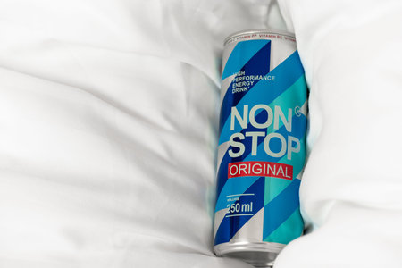 KYIV, UKRAINE - JULY 26, 2023: Can Non Stop energy drink on a white pillows