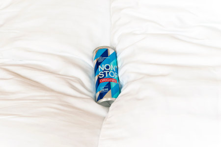 KYIV, UKRAINE - JULY 26, 2023: Can Non Stop energy drink on a white pillows