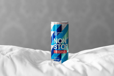 KYIV, UKRAINE - JULY 26, 2023: Can Non Stop energy drink on a white pillows on grey wall backgroundのeditorial素材