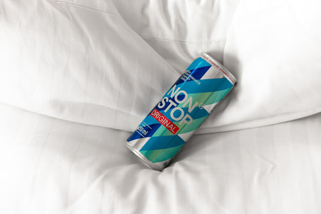 KYIV, UKRAINE - JULY 26, 2023: Can Non Stop energy drink on a white pillows