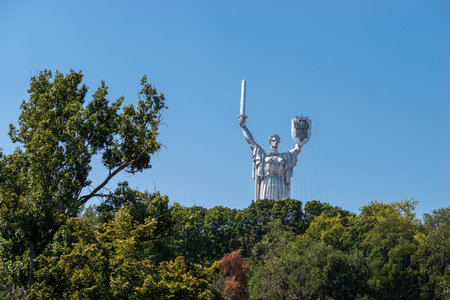 Kyiv, Ukraine - 06 August 2023: Decommunization of the Mother Ukraine. Replacing the coat of arms of the USSR with the Ukrainian trident on the shield of the monument.のeditorial素材