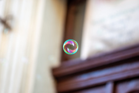 Minimalist dreamy image of a single soap bubble floating in the air with lots of copy space