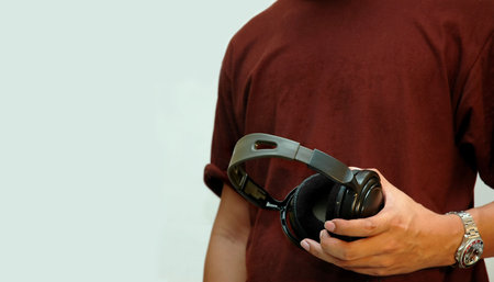 Closeup man holding earphoneの写真素材