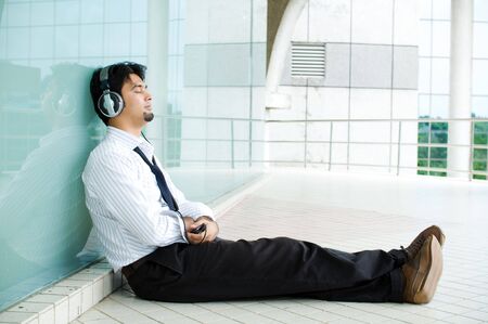 Businessman enjoy listening musicの写真素材