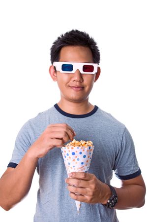Man watching 3D movies while eating popcornの写真素材