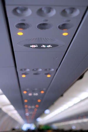 Closeup of wear the seatbelt signage inside the aircraftの写真素材