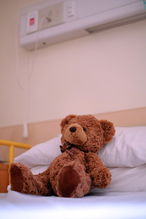 Sick teddy bear on the hospital bedの写真素材