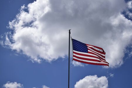 An American flag waving in the clouds in Hudson, Florida.の写真素材