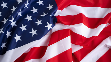 A close-up shot of a draped American flag reveals the texture and detail of the fabric.  The deep...