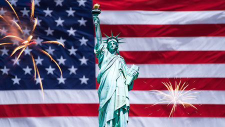 A photograph depicts the Statue of Liberty in front of a large American flag.  Fireworks explode on...