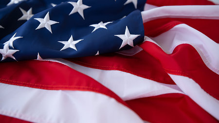 A detailed close-up shot of an American flag reveals the texture of the fabric and the stitching....