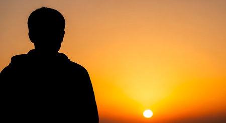 Silhouette of a man on the background of the setting sunの写真素材