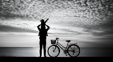 Silhouette of a woman with bicycle at the seaside.の写真素材