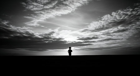Silhouette of a man standing in the middle of the desertの写真素材