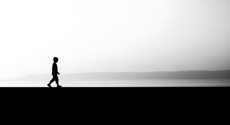 Silhouette of a man walking on the promenade.の写真素材