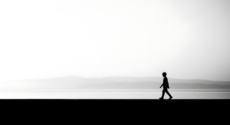 Silhouette of a man walking on the edge of the roadの写真素材