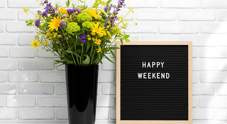 Black letterboard with happy weekend text and flowers. Clear details and vibrant colors enhance v...の写真素材