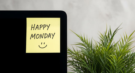 Yellow sticky note with "Happy Monday" and smiley face on black. Clear details and vibrant colors...の写真素材