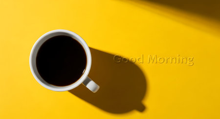 White coffee cup with black coffee on yellow background with shadow. Clear details and vibrant co...