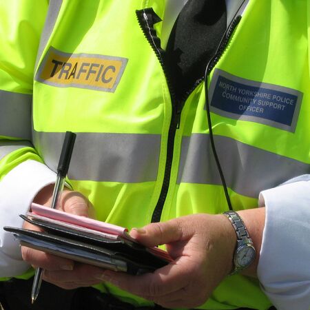 Close-up of community support police officer issuing parking ticketsの写真素材