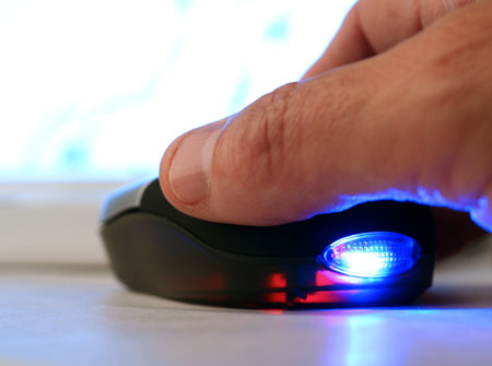 Closeup showing man's hand using computer mouseの写真素材