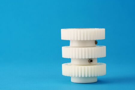 Three white cogwheels stacked on top of each other.の写真素材