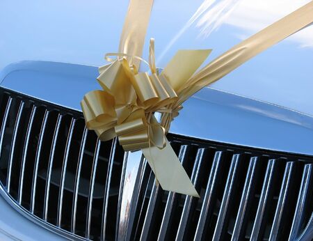 Close-up of ribbon on hood of wedding car.の写真素材