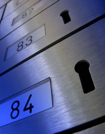 Distorted view of letter boxes with keyholes. Overlaid with blue for effect.の写真素材