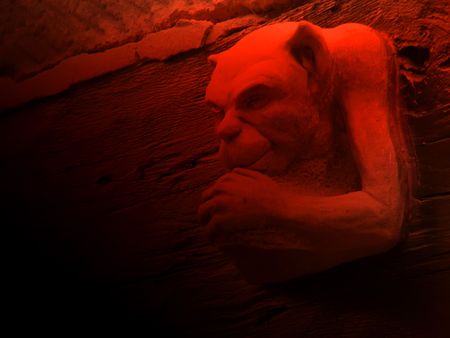 Close up of gargoyle with red lighting effectの写真素材