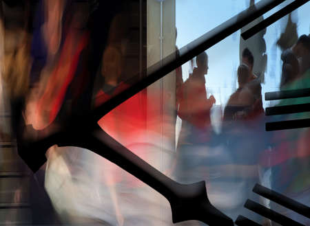 Busy people moving on stairwell overlaid with clock faceの写真素材
