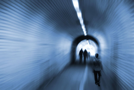 Surreal composition of blurred people inside tunnel
