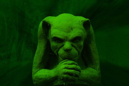 Green gargoyle figure on grunge backgroundの写真素材