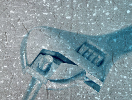 Grunge texture applied to spanner gripping nut and boltの写真素材