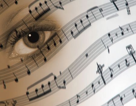 Conceptual image of woman's eye over sheet musicの写真素材