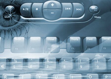 Media computer keyboard overlaid with eye abstractの写真素材