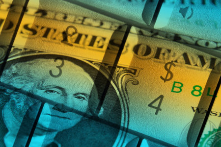 US dollar bank note overlaid onto computer keysの写真素材