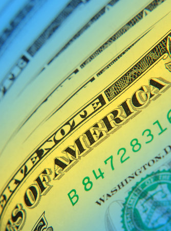 Close-up of US dollar overlaid with yellow blue colour