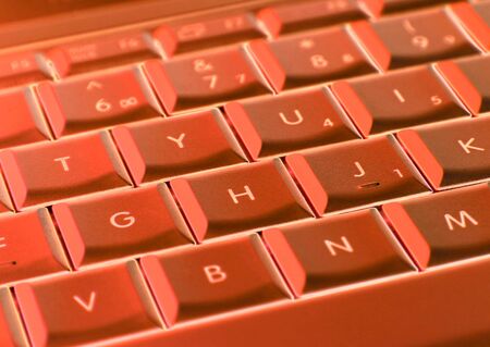 Close-up of laptop keyboard overaid with red colorの写真素材
