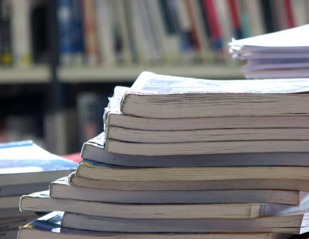 Close-up of pile of text books in library