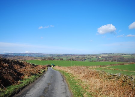 Tractor turns on to country road in Yorkshire moorsの写真素材