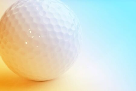 Close-up of golfball overlaid with yellow and blue colorの写真素材