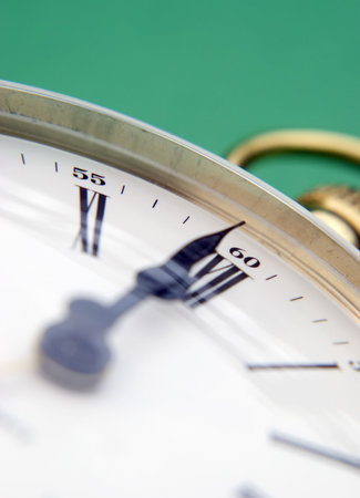 Close-up of clock face over green background