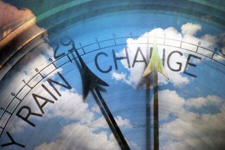 Conceptual image showing old barometer overlaid with cloudy skyの写真素材