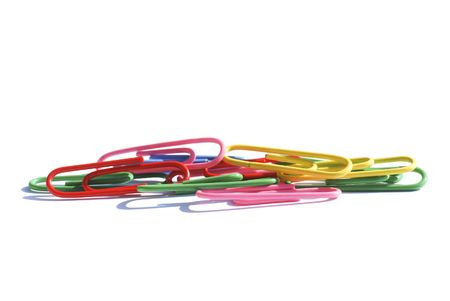 Close-up of colored paperclips over white backgroundの写真素材