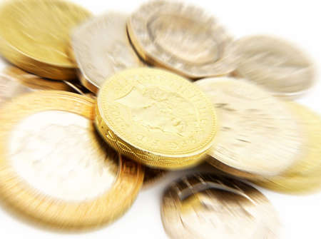 Close-up of UK coins on white with zoom effect on pound coinの写真素材
