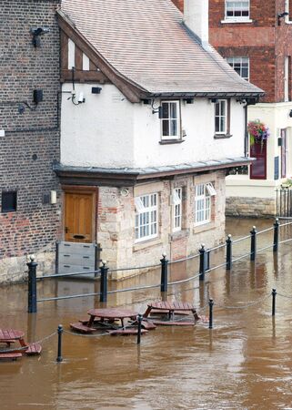 Flooded waters from River Ouse surround riverside pub in York.の写真素材