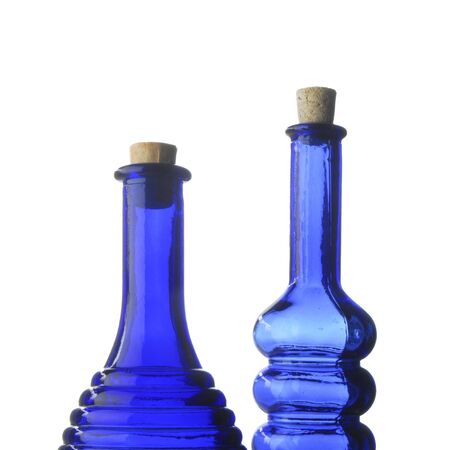 Closeup of two blue decorative bottles on whiteの写真素材